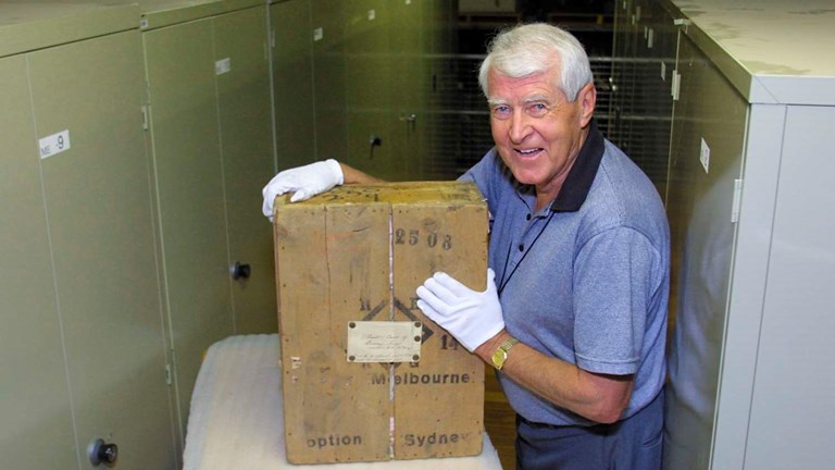 Man with a crate in a museum store