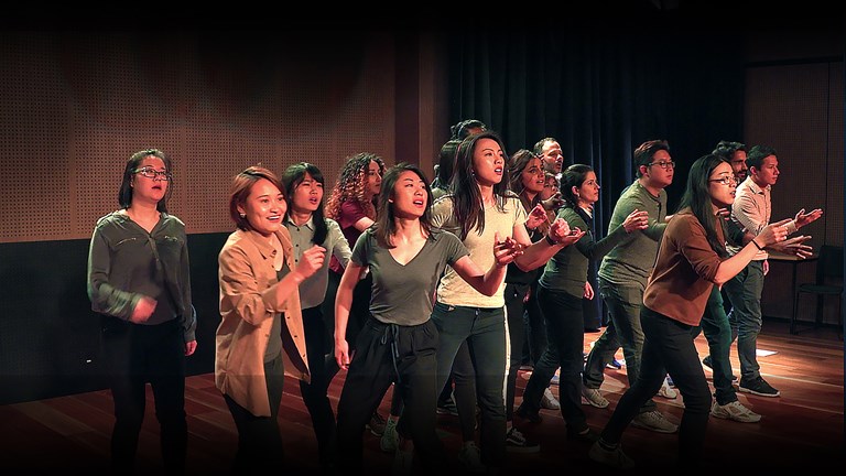 Students on stage performing ‘She’ll Be Right’. Still from the film Acts of Translation, 2018