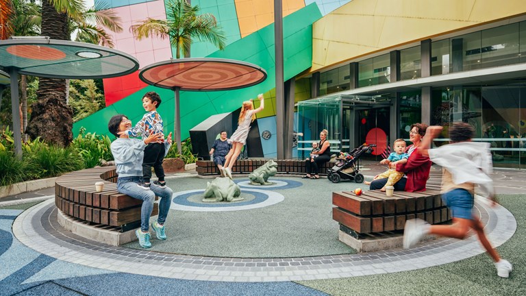 Families playing in the garden at the Children's Gallery