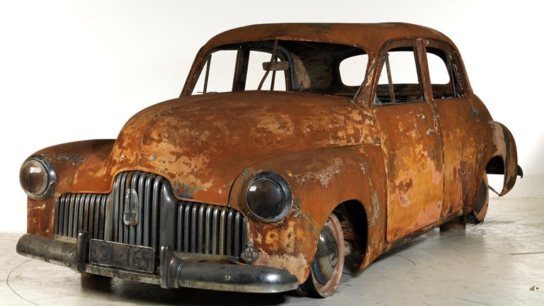 Fire damaged vintage Holden car.