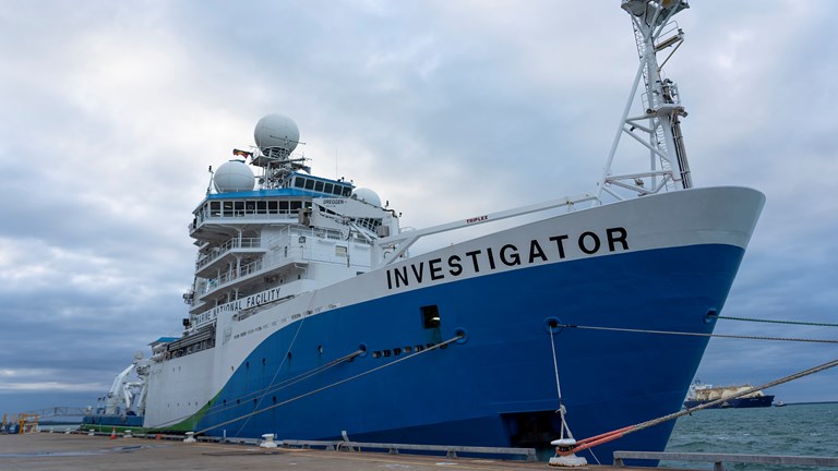 A large research ship sits at a dock in Darwin