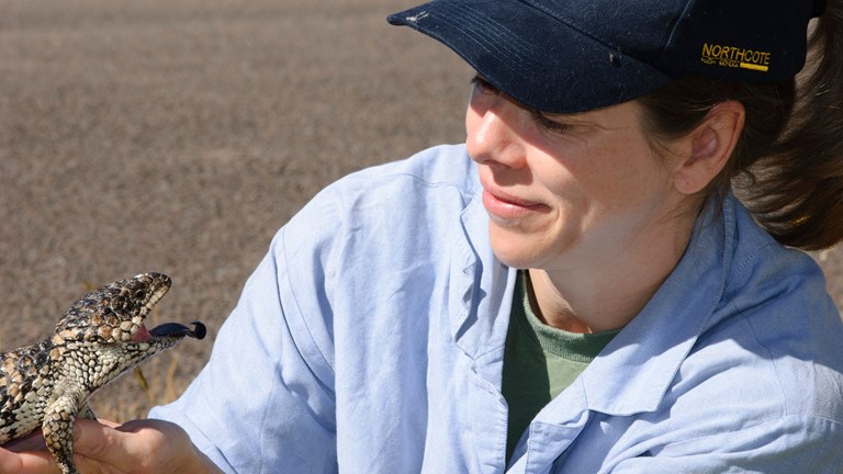 Joanna Sumner holding a lizard