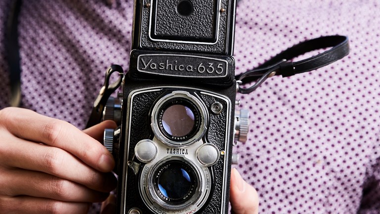 Man holding an old camera