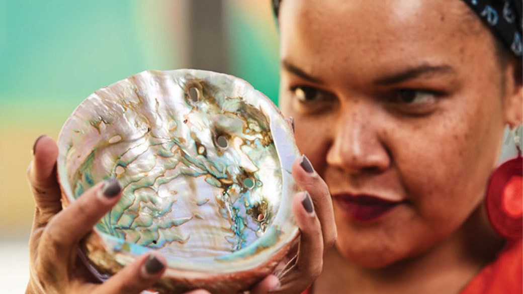 A museum worker inspects a specimen.