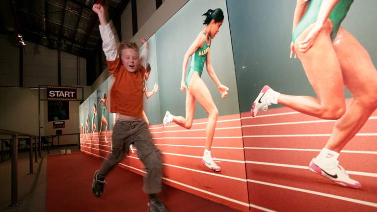 Boy racing against Cathy Freeman at Sportsworks