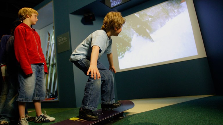 boys using the snowboard interactive