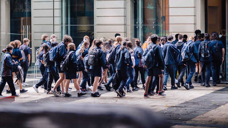 A group of students entering the Immigration Museum from the courtyard.