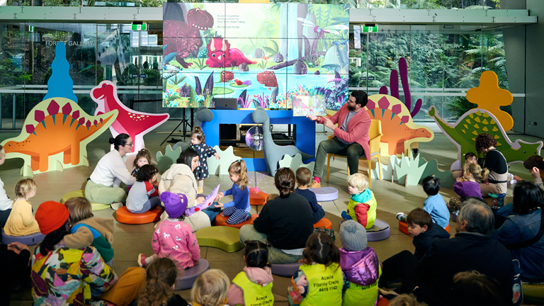 Children being read to during a Dino Day at Melbourne Museum.