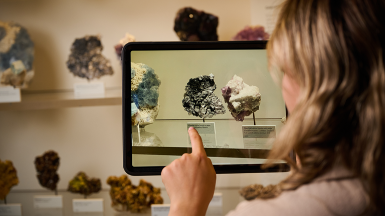 Student using an ipad to video rocks in the Dynamic Earth Gallery within Rockumentary education program at Melbourne Museum